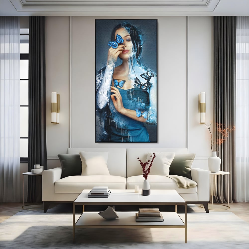 Tablou canvas cu portret feminin cu fluturi albastri, in rama de aluminiu negru, pe perete intr-un living